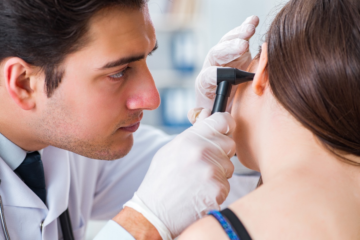 doctor checking patients ear during medical examination